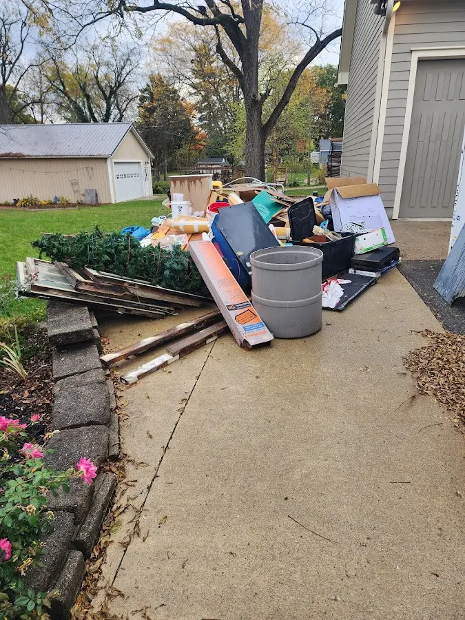 Dumpster being loaded with debris for Estate Cleanout Dumpster Rental in Sulphur